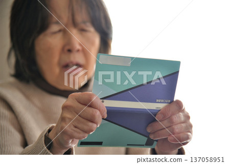 Seniors checking their savings passbook Seniors checking their savings passbook 137058951