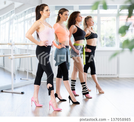 Women perfecting walk during high heels dance class 137058985