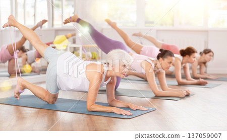 Elderly woman exercising with pilates loop 137059007
