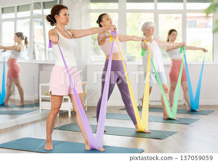 Adult woman exercising with pilates band Adult woman exercising with pilates band 137059059