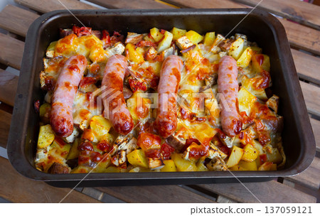 Baked vegetables with sausages Baked vegetables with sausages 137059121