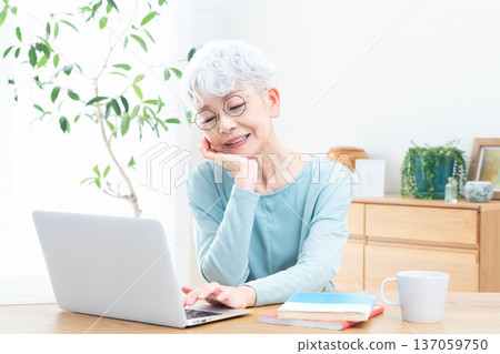 Senior woman thinking in front of a personal computer Senior woman thinking in front of a personal computer 137059750