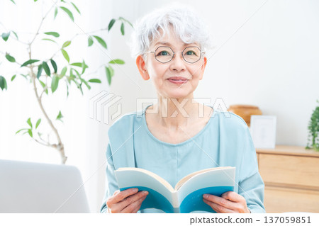 Senior woman reading a book Senior woman reading a book 137059851