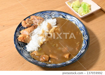 A hearty chicken curry served with crispy fried chicken 137059992
