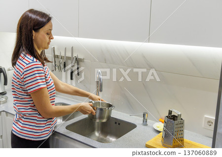 Woman cooking food at home kitchen 137060889