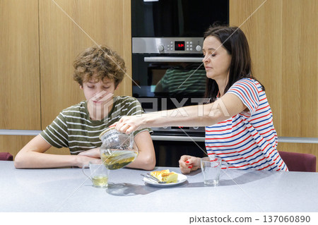 Mother and son drinking tea at home 137060890