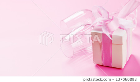 Gift box and wine glasses on pink background Gift box and wine glasses on pink background 137060898