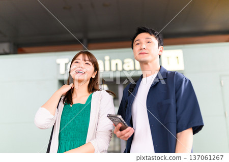 Expecting couple at the airport Expecting couple at the airport 137061267
