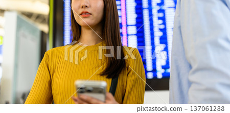A woman checking information at the airport. Photo courtesy of Kansai International Airport (KIX) 137061288