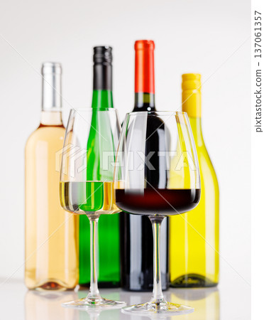 Different wine bottles and glasses on white background Different wine bottles and glasses on white background 137061357