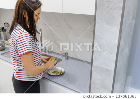 Woman cooking food at home kitchen Woman cooking food at home kitchen 137061363