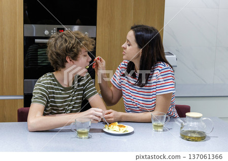 Mother and son drinking tea at home Mother and son drinking tea at home 137061366