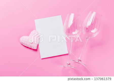 Heart toy and wine glasses on pink background 137061379