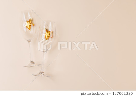 Champagne glasses and decor on beige background Champagne glasses and decor on beige background 137061380