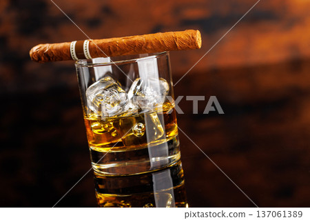 Glass of whiskey with ice and cigar 137061389