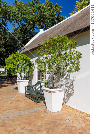 Cozy white house with thatched roof Cozy white house with thatched roof 137061411