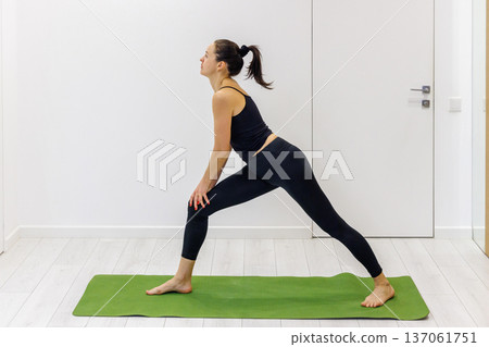 Woman practicing yoga at home Woman practicing yoga at home 137061751