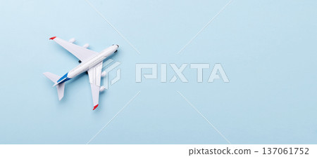 Toy passenger airplane on blue background Toy passenger airplane on blue background 137061752