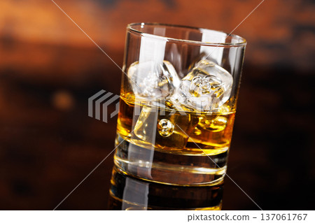 Glass of whiskey with ice 137061767