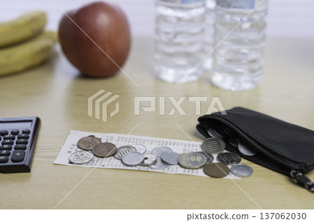 Japanese coins and plastic bags, representing saving money, household management, and shopping 137062030