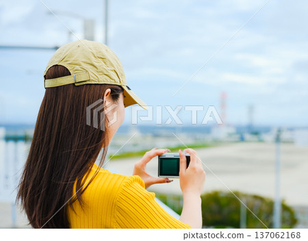 A woman photographed at the beach. Photo courtesy of Kansai International Airport (KIX). 137062168