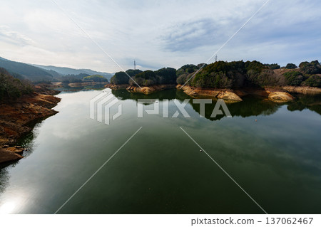 儘管下雨，納拉富梅水壩的水位仍在持續下降。天空倒映在剩餘的湖面上。 137062467