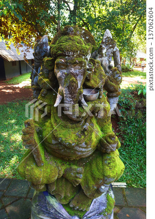 Moss Covered Ganesha Statue in Garden at Chiang Rai Thailand Moss Covered Ganesha Statue in Garden at Chiang Rai Thailand 137062604