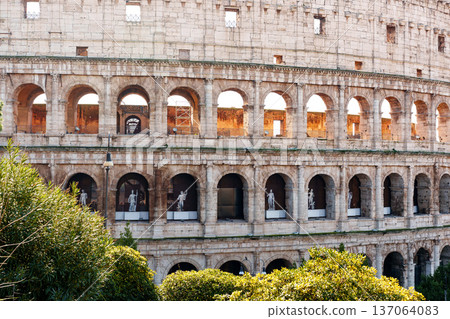 Visitors explore the Colosseum in Rome during the daytime with sculptures in view 137064083