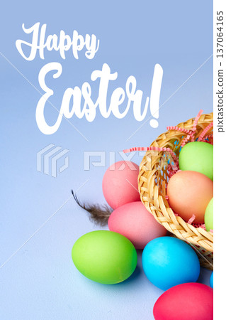 Festive basket filled with colorful Easter eggs on a light blue background Festive basket filled with colorful Easter eggs on a light blue background 137064165