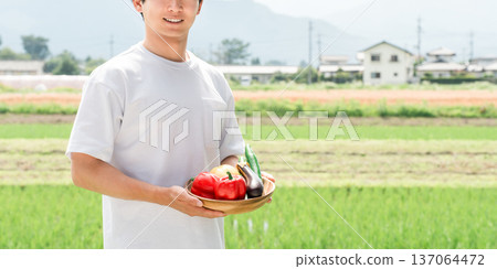 A farmer holding vegetables (farmer, summer vegetables, fresh, hometown tax payment) A farmer holding vegetables (farmer, summer vegetables, fresh, hometown tax payment) 137064472