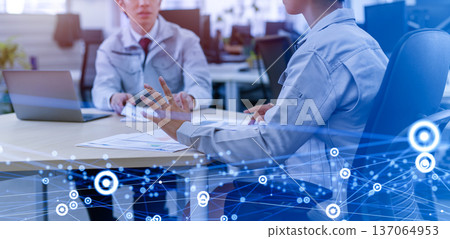 Two people having a meeting in work clothes Two people having a meeting in work clothes 137064953