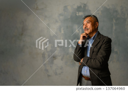 A senior in his 70s thinking about the future with a serious expression 137064960