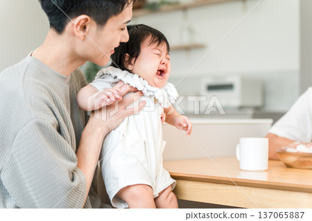 Father soothing a crying, fussy baby Father soothing a crying, fussy baby 137065887