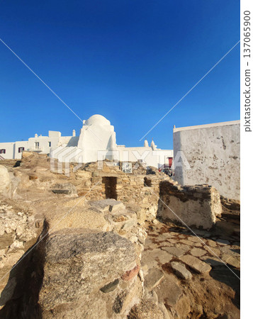 White Church in Mykonos with Tourists under Blue Sky, Greece 137065900