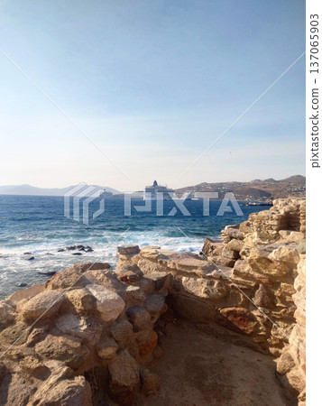 Rocky Coastline of Mykonos with Cruise Ships in Aegean Sea, Greece Rocky Coastline of Mykonos with Cruise Ships in Aegean Sea, Greece 137065903