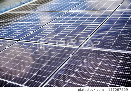 Solar photovoltaic panels on rooftop. Close up of solar batteries installed on top of house. Concept of alternative energy sources in modern life. 137067269
