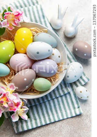 Pastel easter eggs in a bowl with spring flowers Pastel easter eggs in a bowl with spring flowers 137067293
