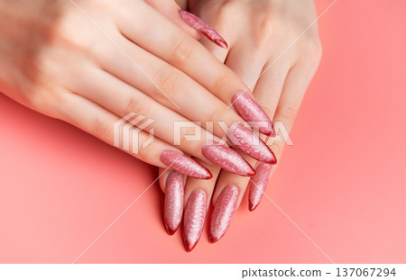 Woman showing stiletto pink and red ombre nails Woman showing stiletto pink and red ombre nails 137067294