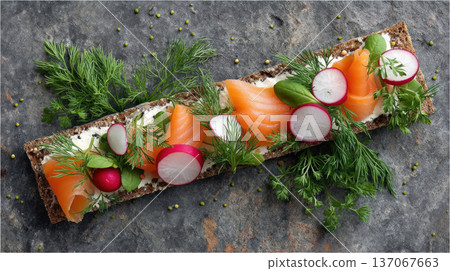 Open faced sandwich with smoked salmon, cream cheese, radish slices, fresh dill, and basil on dark rye bread, garnished with herbs Open faced sandwich with smoked salmon, cream cheese, radish slices, fresh dill, and basil on dark rye bread, garnished with herbs 137067663