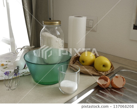 Ingredients for apple pie on kitchen table. High-quality homemade farm products. Healthy eating. Traditional Italian cuisine. Ingredients for apple pie on kitchen table. High-quality homemade farm products. Healthy eating. Traditional Italian cuisine. 137068208