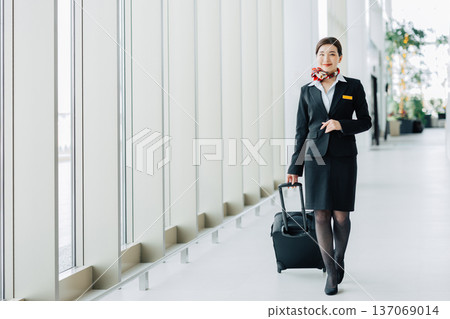 Female flight attendant walking through the airport (Photo courtesy of Kobe Airport (UKB)) 137069014