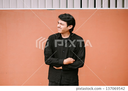 Young Man Grimacing in Pain Holding Stomach 137069542