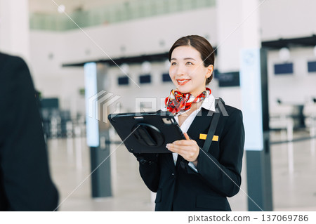 Airport ground staff holding a tablet (Photo courtesy of Kobe Airport (UKB)) 137069786