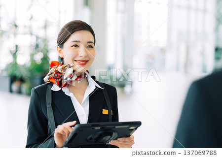 Airport ground staff holding a tablet (Photo courtesy of Kobe Airport (UKB)) 137069788