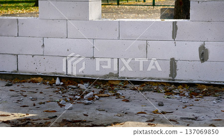 Construction of a wall from white brick blocks 137069850