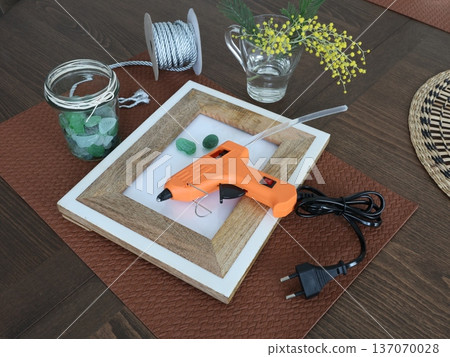 Sea glass for creating framed picture. Natural materials and recycling. Nature and ecology. Glue gun and other tools. Hobbies and creativity. 137070028