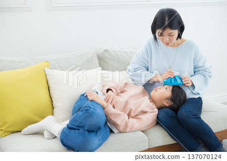Mom caring for her sick daughter Mom caring for her sick daughter 137070124