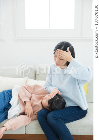 Mom caring for her sick daughter Mom caring for her sick daughter 137070130