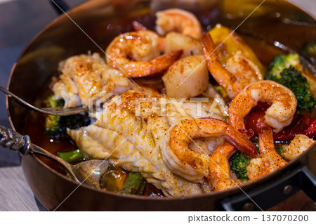 Spanish-style seafood stew cooked in an elegant copper pot 137070200