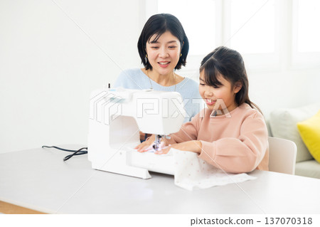 A woman sewing with a sewing machine A woman sewing with a sewing machine 137070318